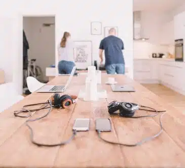 orange and black headphones on table