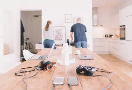 orange and black headphones on table